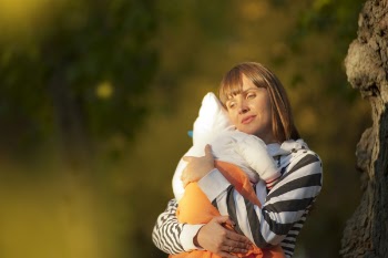 Selective Focus Photo Of Woman Carrying Baby