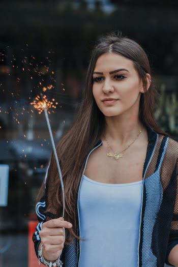 Selective Focus Photo of Woman Holding Firecracker