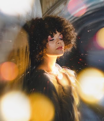 Selective Focus Photo of Woman Holding String Lights