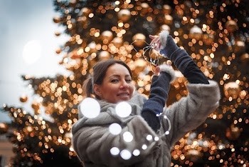 Selective Focus Photo of Woman Holding String Lights