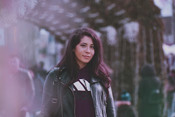 Selective Focus Photo of Woman in Black Leather Jacket Carrying Backpack.