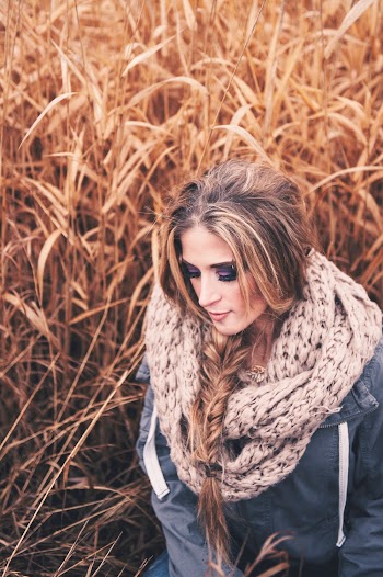 Selective Focus Photo of Woman in Blue Jacket and Knitted Scarf Posing by Tall Brown Grass