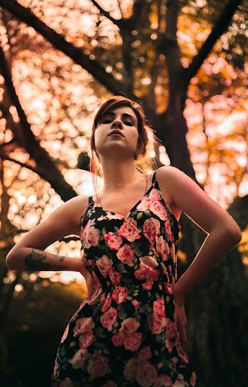 Selective Focus Photo of Woman in Floral Dress Posing With Her Hands Akimbo
