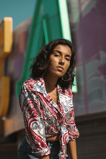 Selective Focus Photo of Woman in Floral Shirt Posing