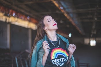 Selective Focus Photo of Woman in Green Denim Jacket and Black T-shirt Posing with Her Eyes Closed
