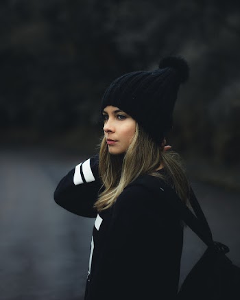 Selective Focus Photo of Woman In Knit Hat and Sweatshirt Looking Away