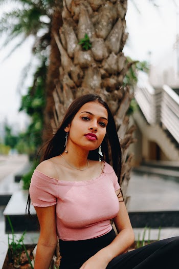 Selective Focus Photo of Woman in Pink Top and Black Skirt Posing