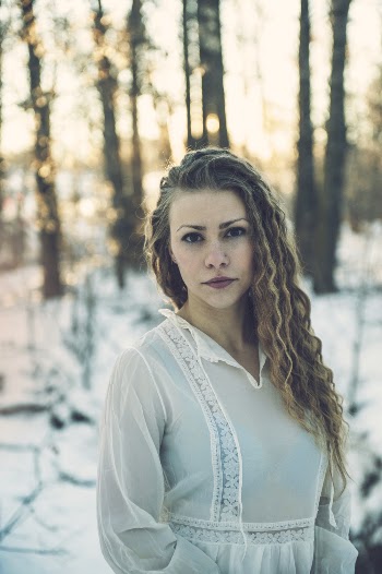 Selective Focus Photo of Woman in White Dress Standing in the Snow Posing