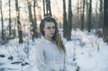Selective Focus Photo of Woman in White Dress Standing in the Snow Posing