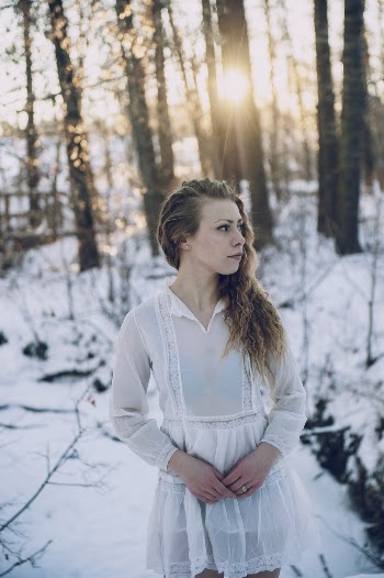 Selective Focus Photo of Woman in White Dress Standing in the Snow Posing While Looking Away