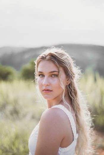 Selective Focus Photo of Woman Posing on Green Grass Field