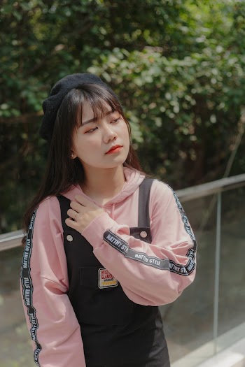 Selective Focus Photo of Woman Posing While Looking Away