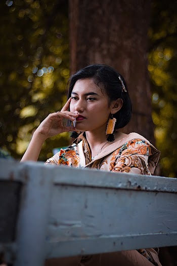 Selective Focus Photo of Woman Resting Her Head