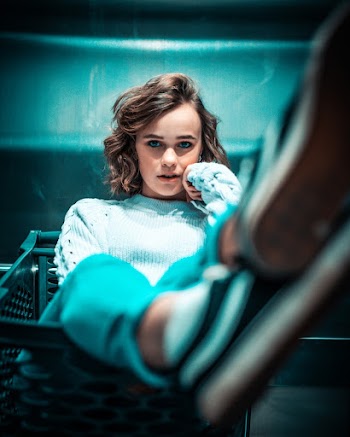 Selective Focus Photo of Woman Sitting on Plastic Basket