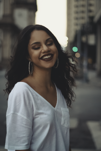 Selective Focus Photo of Woman Smiling While Wearing White Shirt