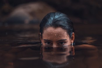 Selective Focus Photo of Woman Soaking on Calm Water