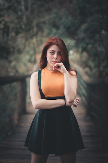 Selective Focus Photo of Woman Standing in the Middle of a Bridge