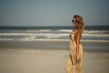 Selective Focus Photo of Woman Standing on Beach Sand