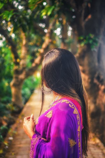 Selective Focus Photo of Woman Standing on Empty Pathway