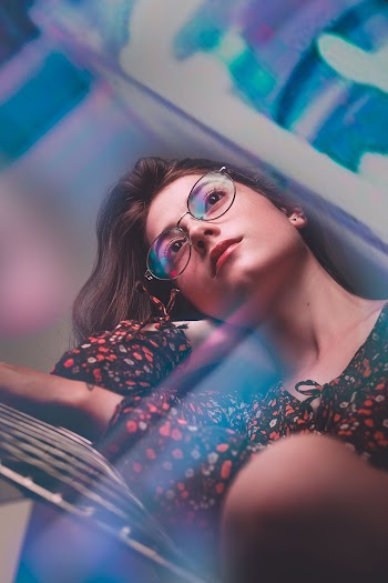 Selective Focus Photo of Woman Wearing Eyeglasses and Floral Top