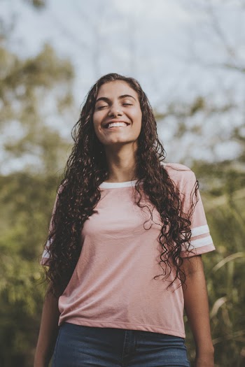 Selective Focus Photo of Woman Wearing Pink and White Crew-neck T-shirt