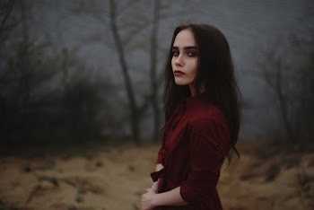 Selective Focus Photo of Woman Wearing Red Velvet Elbow-sleeved Top