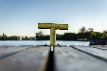 Selective Focus Photo of Yellow Bollard