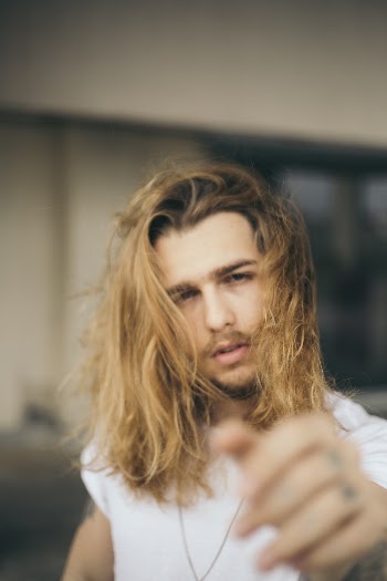 Selective Focus Photograph of Man in White Shirt