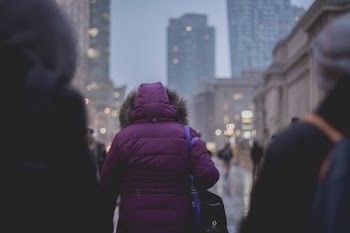 Selective Focus Photograph of Person Wearing Purple Hoodie Jacket Walking on Street