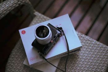 selective focus photography black and gray SLR camera with box