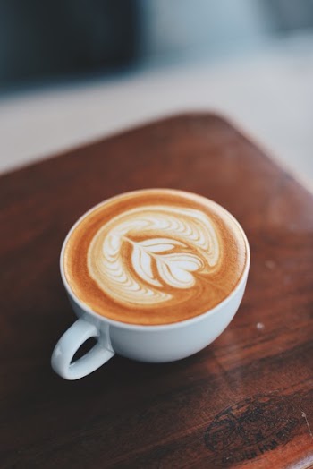 Selective Focus Photography Coffee Cup on Board