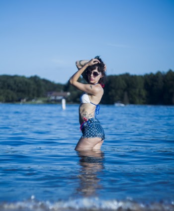 Selective Focus Photography of a Woman on Body of Water