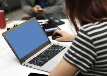 Selective Focus Photography of a Woman Using Laptop