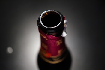 Selective Focus Photography of Amber Glass Bottle Lid