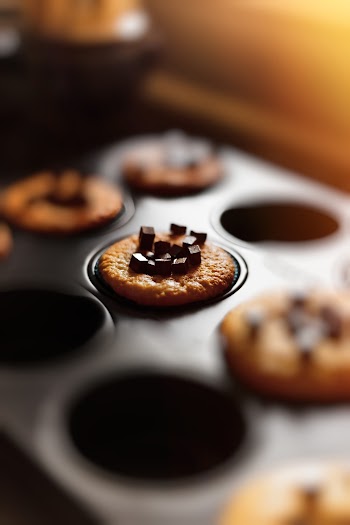 Selective Focus Photography Of Baked Cupcake In Tin With Chocolate Bits On Top