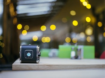 Selective Focus Photography of Black Case on Brown Wooden Surface