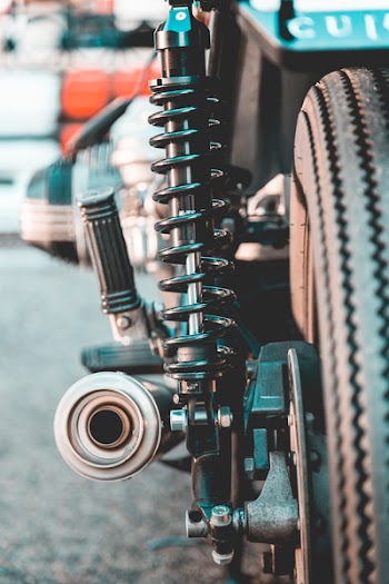 Selective Focus Photography of Black Metal Coilover