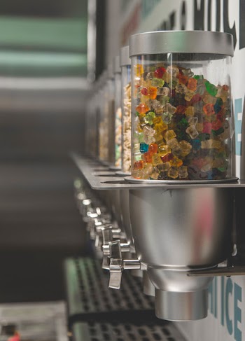 Selective Focus Photography of Candy Dispenser