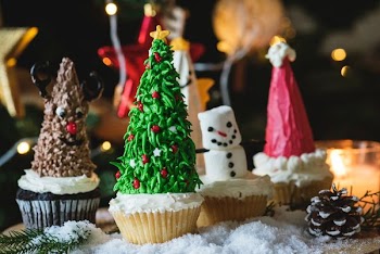 selective focus photography of Christmas-themed cupcakes