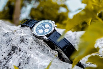 Selective Focus Photography of Chronograph Watch on Rock