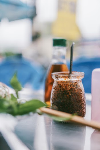 Selective Focus Photography of Clear Glass Jar With Brown Powder