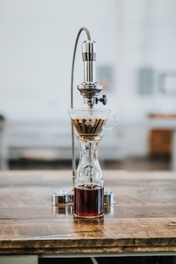 selective focus photography of coffee mixer on table