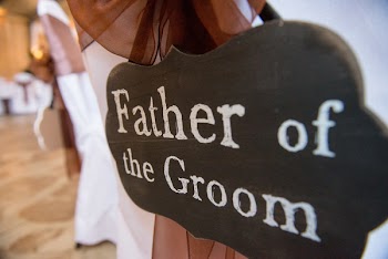 Selective Focus Photography of Father of the Groom Hanging Signage