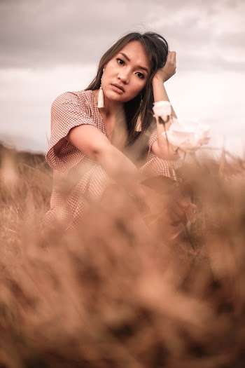 Selective Focus Photography of Girl Sitting On Grass