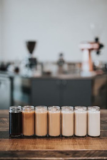 selective focus photography of glass with liquid in it