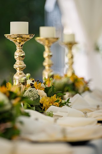 Selective Focus Photography of Gold Candlestick on Table