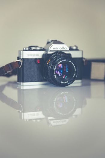 selective focus photography of gray and black Minolta camera