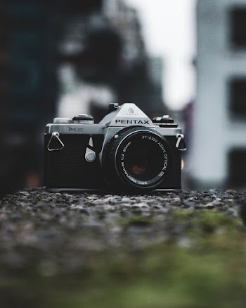 Selective Focus Photography of Gray and Black Pentax Camera on Gray Surface