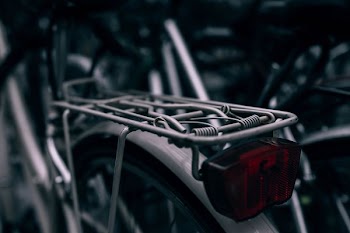 selective focus photography of gray bicycle rack