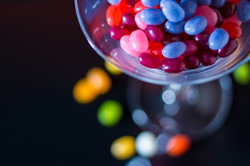 Selective Focus Photography of Jelly Beans on Jar